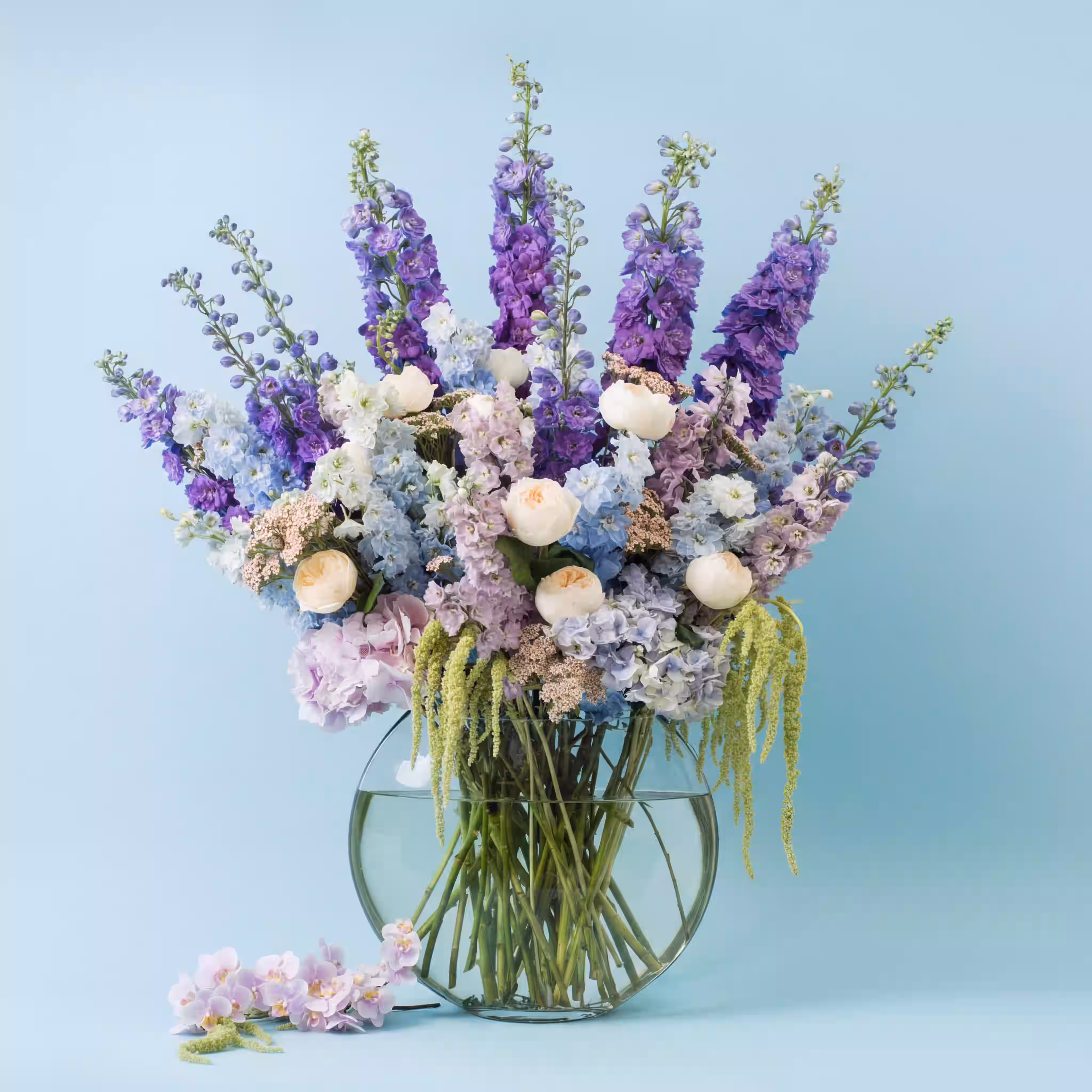 Luxury delphinium and rose bouquet in a glass vase by Moyses Stevens