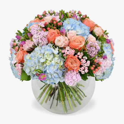 Blue dawn luxury flower bouquet by Moyses Stevens UAE featuring pink bouvardia, hypericum, spray roses, freesias and carnations to make the design truly irresistible