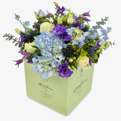 Blue sky luxury flower bouquet by Moyses Stevens UAE featuring Blue Hydrangeas, White Roses, Purple Lisianthus, Purple Clematis, Blue Delphinium, Yellow Solidago, Eucalyptus