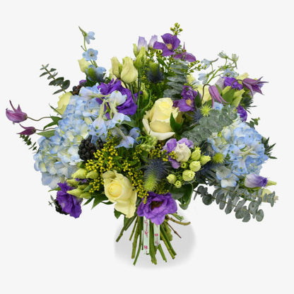 Blue sky luxury flower bouquet by Moyses Stevens UAE featuring Blue Hydrangeas, White Roses, Purple Lisianthus, Purple Clematis, Blue Delphinium, Yellow Solidago, Eucalyptus