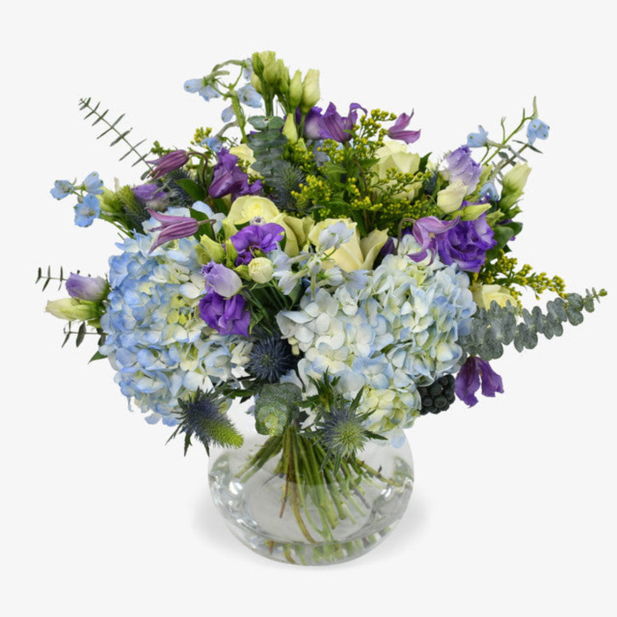 Blue sky luxury flower bouquet by Moyses Stevens UAE featuring Blue Hydrangeas, White Roses, Purple Lisianthus, Purple Clematis, Blue Delphinium, Yellow Solidago, Eucalyptus
