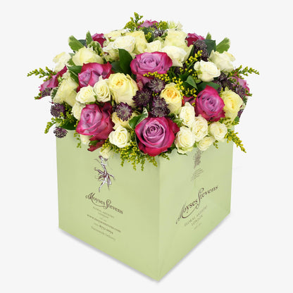 Lemon Meringue luxury flower bouquet by Moyses Stevens UAE featuring yellow and deep purple roses, white spray roses, solidago and astrantia and  seasonal greenery.