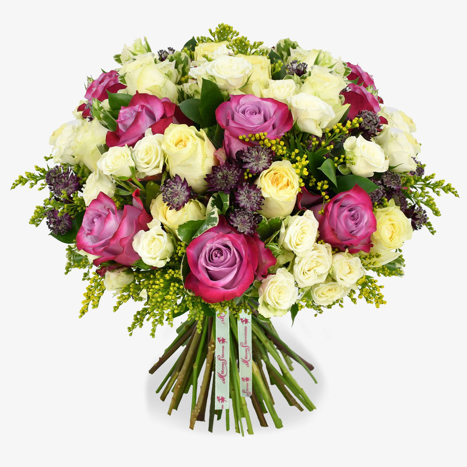 Lemon Meringue luxury flower bouquet by Moyses Stevens UAE featuring yellow and deep purple roses, white spray roses, solidago and astrantia and  seasonal greenery.