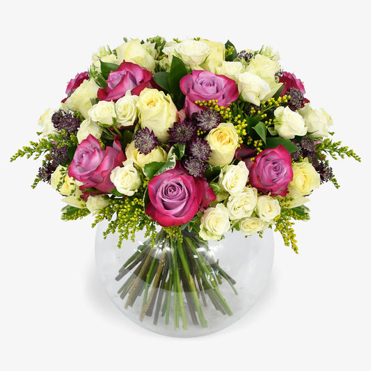 Lemon Meringue luxury flower bouquet by Moyses Stevens UAE featuring yellow and deep purple roses, white spray roses, solidago and astrantia and  seasonal greenery.