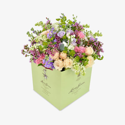 Mellow Meadow luxury flower bouquet by Moyses Stevens UAE featuring fragrant stocks, spray roses, and eucalyptus. With the perfect touch of bold wax flower and vibrant green accents