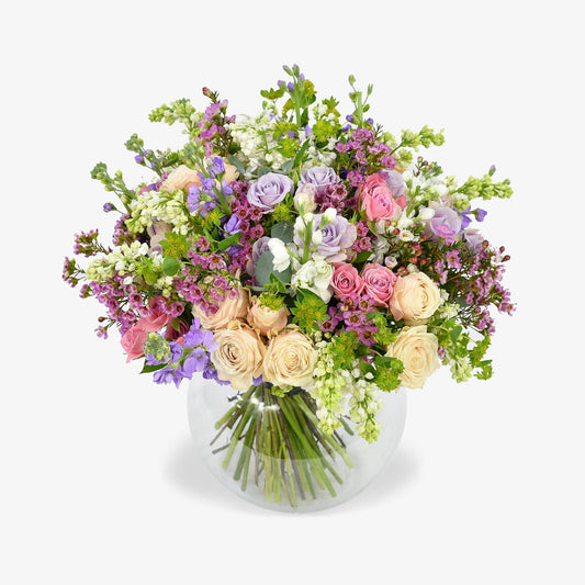 Mellow Meadow luxury flower bouquet by Moyses Stevens UAE featuring fragrant stocks, spray roses, and eucalyptus. With the perfect touch of bold wax flower and vibrant green accents