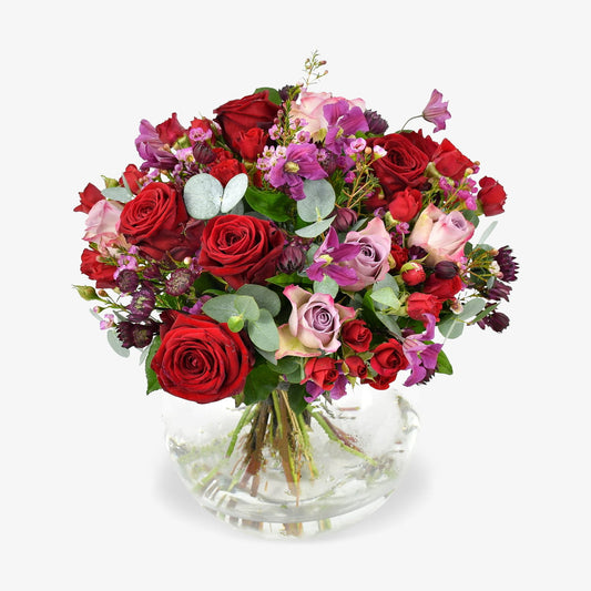 Rennaisance Rose luxury flower bouquet by Moyses Stevens UAE featuring a variety of red and pink roses, spray roses, clematis, wax flower, astrantia, and eucalyptus.