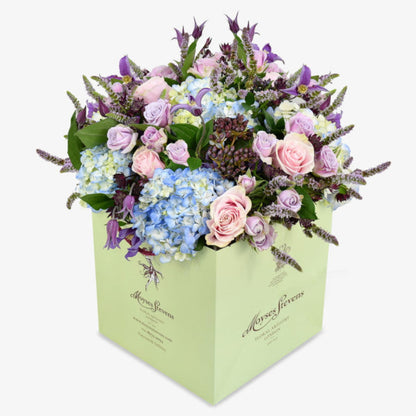 Wild Meadow luxury flower bouquet by Moyses Stevens UAE featuring Delicate lisianthus, roses, and ranunculus which are nestled among cymbidium orchids, while hydrangeas and astrantia provide a stunning backdrop.