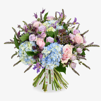 Wild Meadow luxury flower bouquet by Moyses Stevens UAE featuring Delicate lisianthus, roses, and ranunculus which are nestled among cymbidium orchids, while hydrangeas and astrantia provide a stunning backdrop.